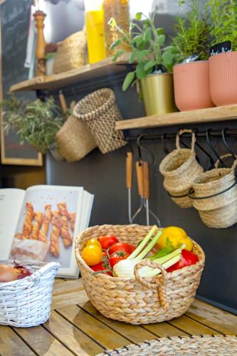 a table with two baskets of vegetables on it at ibis Salon de Provence in Salon-de-Provence