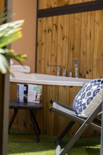 a chair sitting in front of a bathroom sink at Gateway Suites in Rethymno Town