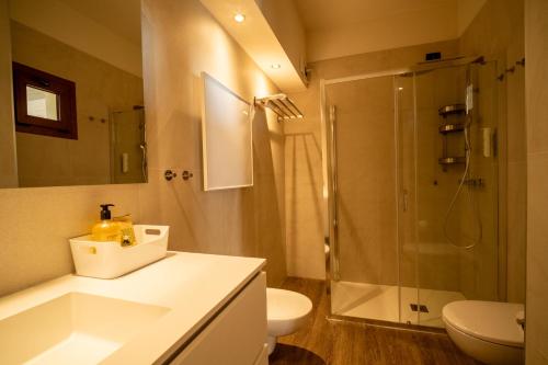 a bathroom with a shower and a sink and a toilet at Hotel Gardenia Sirmione in Sirmione