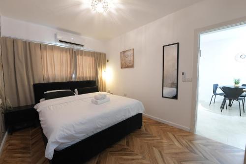 a bedroom with a bed and a table and chairs at La Bonita Eilat Amazing Pool in Eilat