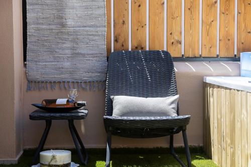 a chair and a side table on a patio at Gateway Suites in Rethymno Town