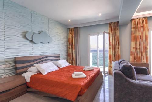 a bedroom with a bed with two towels on it at Corfu Maris in Benitses