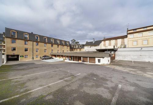 an empty parking lot in front of some buildings at B&B HOTEL Lourdes Centre in Lourdes