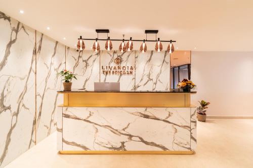 a lobby of a luxury hotel with a marble wall at TGI Livancia The Sojourn in Bengaluru