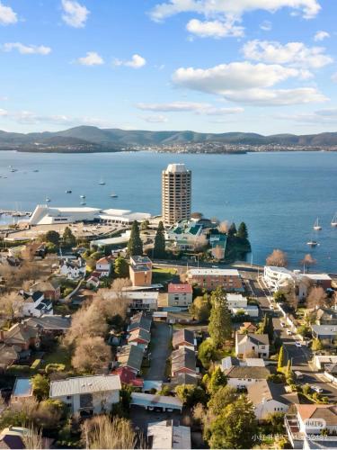 an aerial view of a city and a large body of water at Hobart Bay Sunrise House--Rare Aurora Viewing Opportunities in Hobart