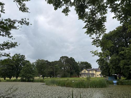 an old house in the middle of a field at The Retreat at Glanrannell Park House in Llanwrda