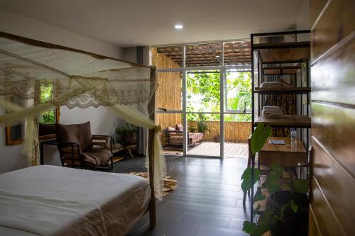 a bedroom with a bed and a view of a patio at Eagle View Lodge - Kigali in Kigali