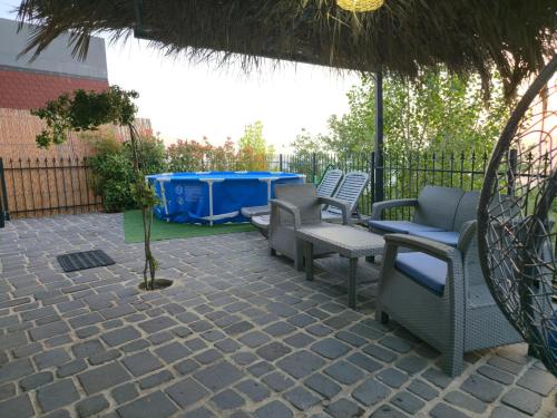 a patio with several chairs and a table at Orion, Hills of Zaarour in Zaarour