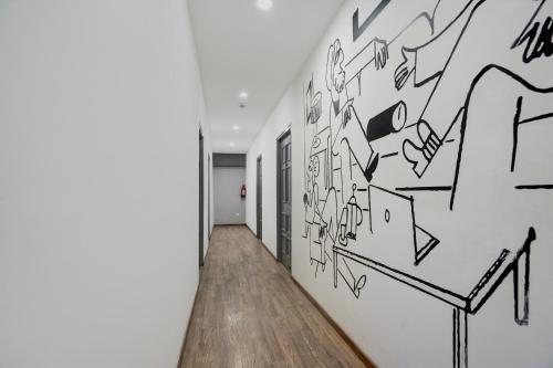 a hallway with graffiti on the wall at Super Townhouse Gomti Nagar Sector 6 Near Ekana Stadium in Lucknow