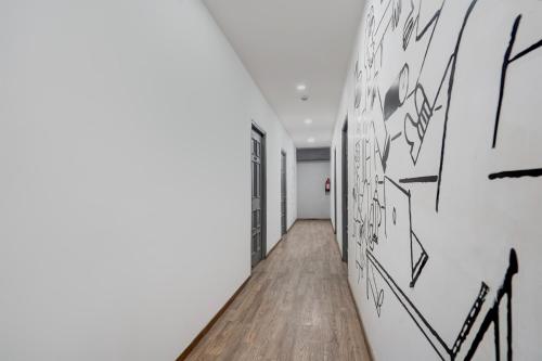 a hallway with black and white paintings on the walls at Super Townhouse Gomti Nagar Sector 6 Near Ekana Stadium in Lucknow