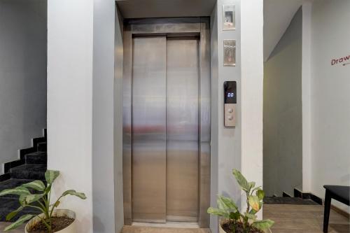a elevator in a building with plants at Super Townhouse Gomti Nagar Sector 6 Near Ekana Stadium in Lucknow