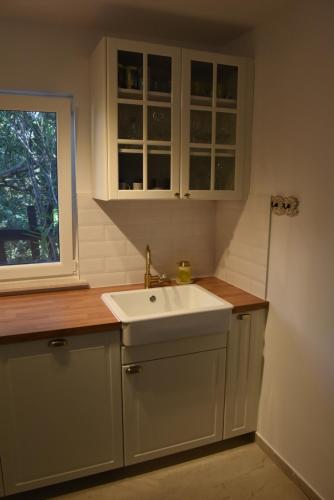 een keuken met een witte wastafel en een raam bij Family House Stara Novalja in Stara Novalja