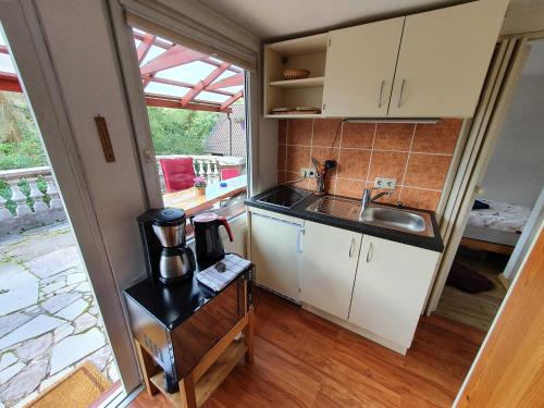 a small kitchen with a sink and a counter at Ferienhaus _Am Hexenstieg_ in Rübeland
