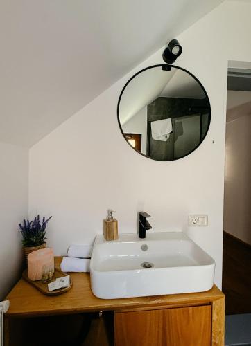a bathroom with a white sink and a mirror at Walthaus in Vulcan