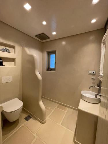 a bathroom with a toilet and a sink at Villa Kouneli - an exceptional holiday in Koundouros