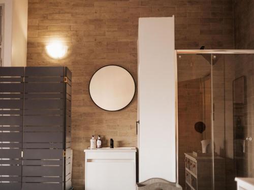 a bathroom with a mirror on a brick wall at Kudu Kopje Lodge in Kroondal