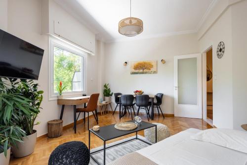 a living room with a couch and a table at Renovated apartment near Acropolis in Athens