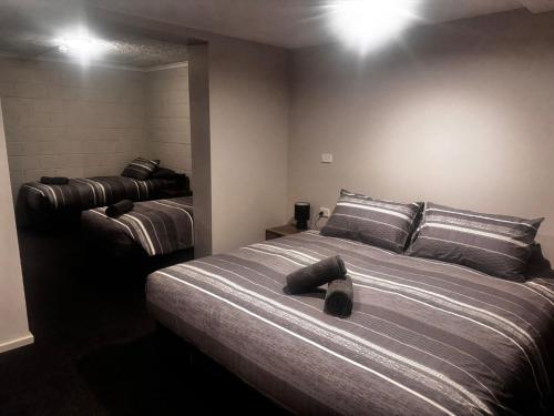 a bedroom with a large bed and a mirror at Cooroona Alpine Lodge in Falls Creek