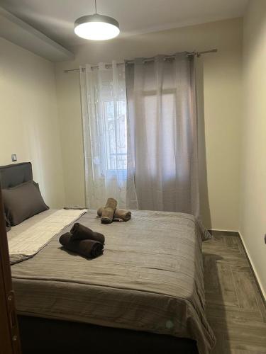 a large bed in a bedroom with two pillows on it at The harmony of the center in Kilkís