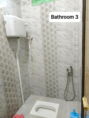 a bathroom with a toilet and a shower at ZIYA Homestay in Jertih
