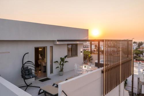 a house with a balcony with a view of the city at Jimmy’s Garden in Faliraki