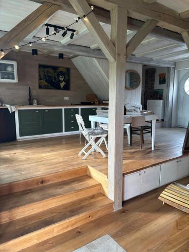 a kitchen and dining room with a table and chairs at Stodola Jankovna 