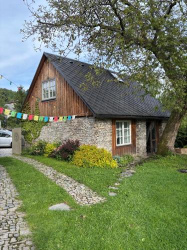 a house with a flag banner in front of it at Stodola Jankovna 