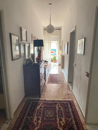 a hallway with a living room with a rug at Ars in Villa in Livorno