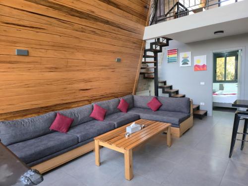 a living room with a couch and a wooden wall at Orion, Hills of Zaarour in Zaarour