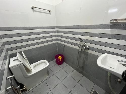 a bathroom with a toilet and a sink at Phoenix Odayam in Kappil