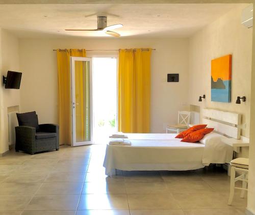 a bedroom with a bed and a large window at Hotel Santo Stefano in Portoferraio