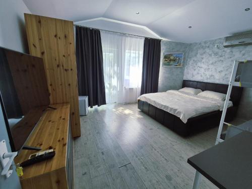 a bedroom with a bed and a desk in a room at Casa Elena in Eforie Sud