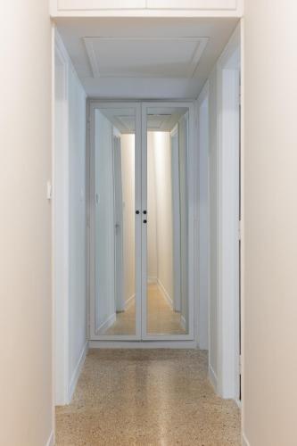 an empty room with a mirror and a hallway at Renovated apartment near Acropolis in Athens