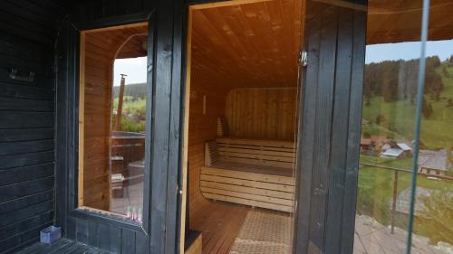an outside view of a sauna in a house at Gyimesi Skanzen in Valea Boroş
