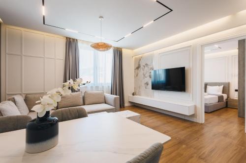 a living room with a couch and a tv at Hotel Teuta in Ulcinj