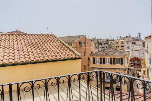 a view of a city from a balcony at Ionian Pearl Apartments And Suites in Corfu Town