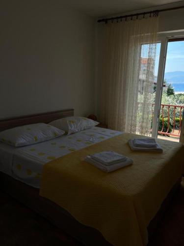 a bedroom with a bed with two towels on it at Moretino Supetar in Supetar