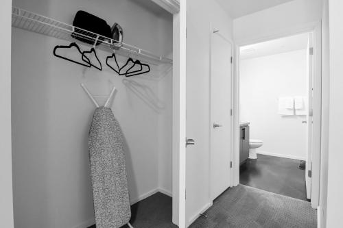 a room with a closet with a tie on a rack at Centric 2BR In HEART of DTPHX Free Garage Parking in Phoenix