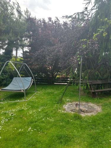 a hammock in the grass in a yard at Relaks XXL in Kartuzy