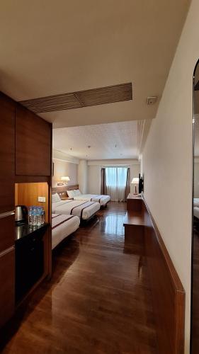Postel nebo postele na pokoji v ubytování Cheng Pao Hotel