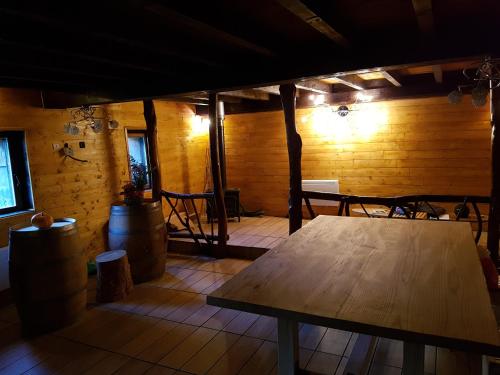 a room with a wooden table and a room with a barrel at gîte, grange aménagée in Luz-Saint-Sauveur