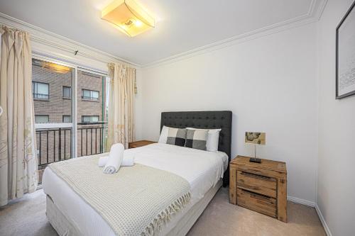 a bedroom with a large bed and a window at Comfort Stay in Bankstown Free Parking in Bankstown