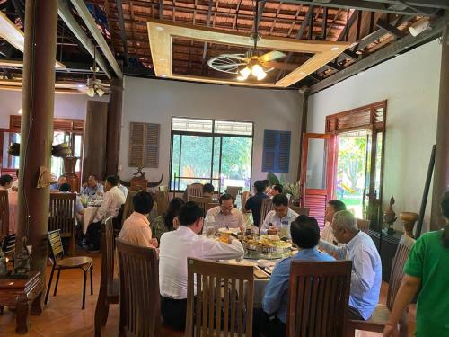 un gruppo di persone sedute ai tavoli di un ristorante di Phum Khmer Resort a Banlung