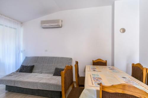 a bedroom with a bed and a table and chairs at Barbic - SG - MPolo in Medulin