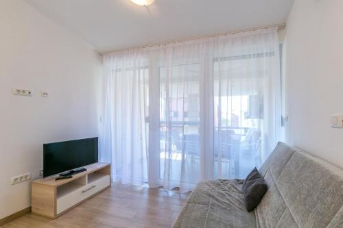 a living room with a couch and a television at Barbic - SG - MPolo in Medulin