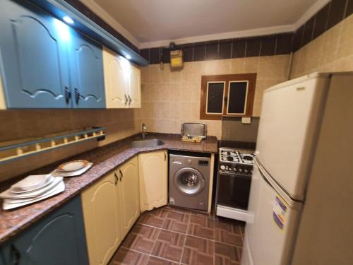 a kitchen with a refrigerator and a washer and dryer at Time Off in Alexandria