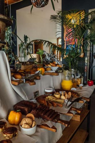 a table topped with lots of different types of bread at Eagle View Lodge - Kigali in Kigali