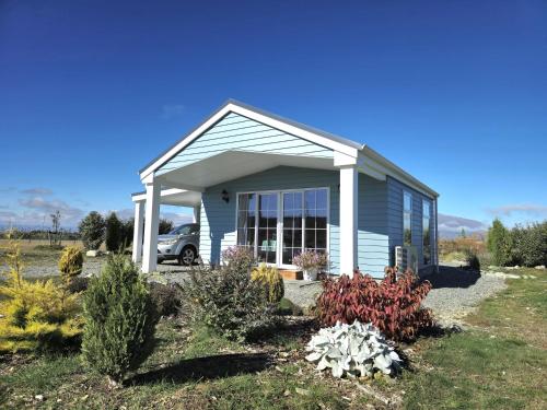 a small house with a car parked in front of it at Kahurangi Cottage Twizel in Twizel