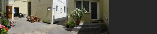a building with a staircase leading to a white door at Penzion U Hradeb in Znojmo