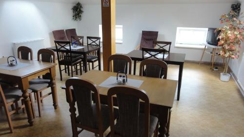 a group of tables and chairs in a room at Penzion U Hradeb in Znojmo